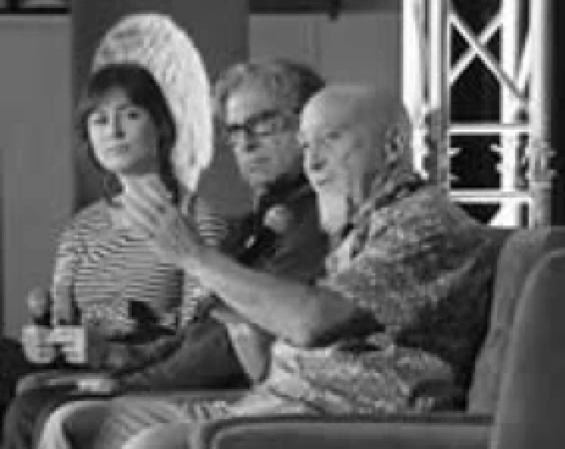 dr stuart hamerroff sitting on a chair, speaking to an audience
